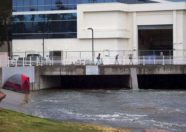 Stormwater runoff flows into a culvert by the Hard Rock Sunday, Jan. 22, 2017. Three people were reported washed away by the runoff but were rescued downstream by the Clark County Fire Department.
