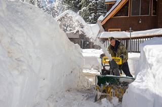 Kevin Hearn uses a snowblower to clear a path from his cabin in the Cathedral Rock subdivision on Mount Charleston Tuesday, Jan. 24, 2017. Residents in Kyle Canyon are digging out after the weekend storms.