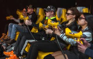 Wind blows the hair of players shoot at the bad guys during a Dark Ride XD ride at Gameworks at Town Square where they are unveiling the new 7-D cinema experience on Thursday, Jan. 26, 2017.