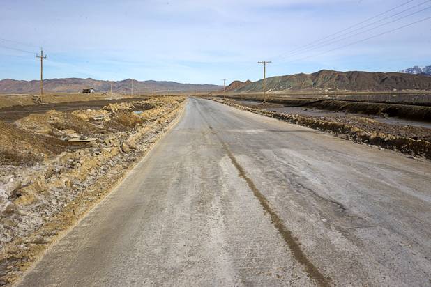 Silver Peak Road, a public roadway, cuts through a valley floor where the Silver Peak lithium mine has its evaporation ponds near Tonopah, Nev. Monday, Jan. 30, 2017.