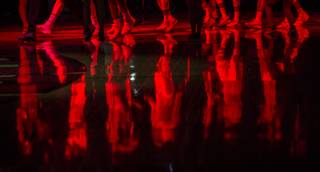UNLV players are reflected on the court as the opening fireworks conclude before their game at the Thomas & Mack Center on Wednesday, Feb. 1, 2017.