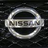 This Feb. 14, 2013, file photo shows the Nissan logo on the grill of a 2013 Nissan Pathfinder on display at the 2013 Pittsburgh Auto Show in Pittsburgh.