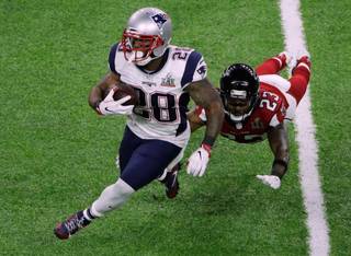 New England Patriots' James White, left, breaks a way from Atlanta Falcons' Robert Alford during the first half of the NFL Super Bowl 51 football game Sunday, Feb. 5, 2017, in Houston. (AP Photo/Charlie Riedel)