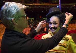Roger J. Stricker, left, makes adjustments to Young Ringmaster (Jimmy Slonina) during a preview of the fifth annual one-night-only One Night for One Drop benefit show at the Zumanity Theater at New York-New York Tuesday, Feb. 7, 2017. The show is scheduled for March 3, 2017. One Drop is an international Non-profit organization. .