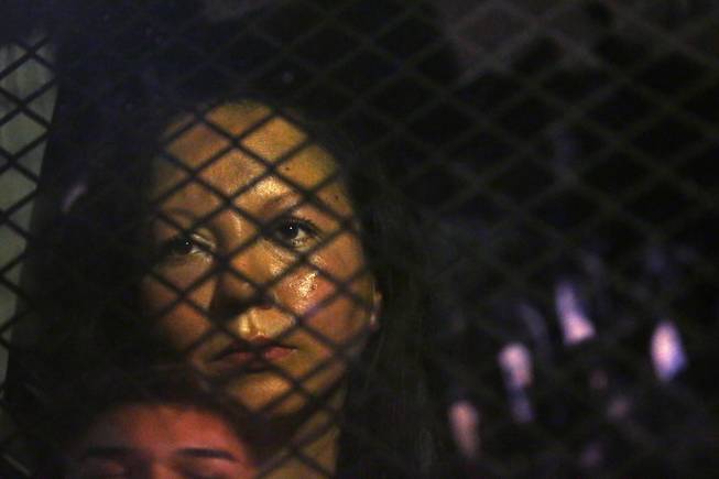 Guadalupe Garcia de Rayos is locked in a van stopped in the street by protesters outside Phoenix's ICE facility on Feb. 8. Detained by immigration officials after a scheduled meeting she attended even though she feared the consequences, Rayos was deported to Nogales, Mexico after 21 years of being in the U.S. 