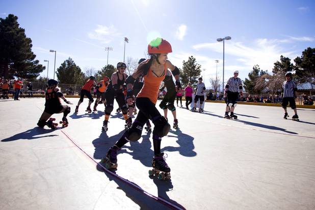 Haulin, the jammer from the Orange team, skates past a block to score during the Sin City Roller Girls annual Black vs Orange season kickoff scrimmage game at West Flamingo Park, Saturday, February 4, 2017.