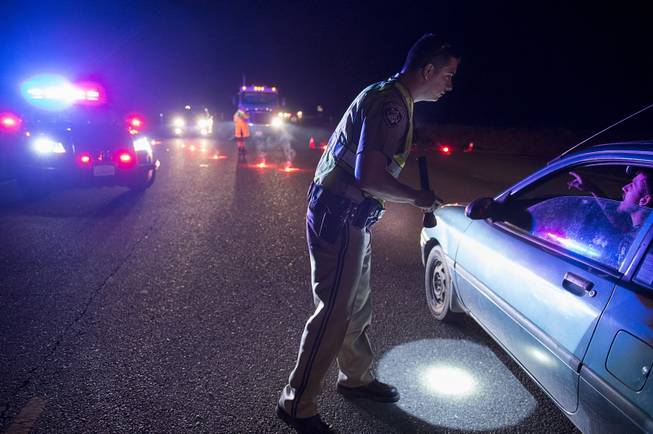 California Highway Patrol officer Ken Weckman directs traffic as residents evacuate Marysville, Calif., Sunday, Feb. 12, 2017. Thousands of residents of Marysville and other Northern California communities were told to leave their homes Sunday evening as an emergency spillway of the Oroville Dam could fail at any time unleashing flood waters from Lake Oroville, according to officials from the California Department of Water Resources. (Paul Kitagaki Jr./The Sacramento Bee via AP)