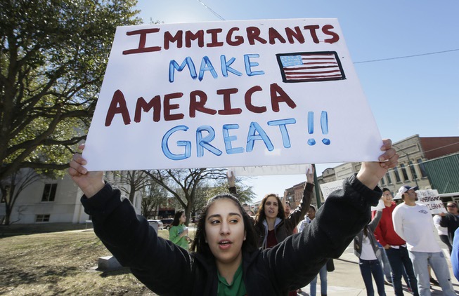 High school student Kathia Suarez holds up a sign as ...