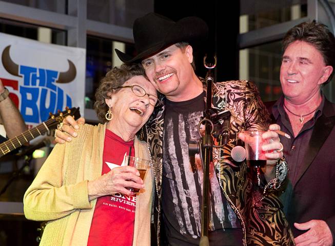 Granny Rich celebrates with her grandson John Rich during the grand opening of Redneck Riviera, a country bar in the Grand Bazaar Shops in front of Bally's, Thursday, Feb. 16, 2017. Singer T.J. Sheppard looks on at right. .
