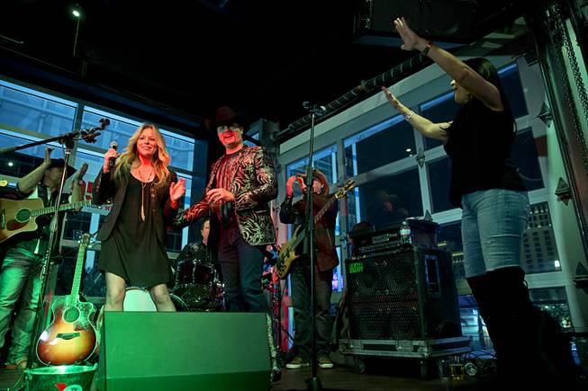 Country singer Deana Carter, left, performs with John Rich during the grand opening of Redneck Riviera, a country bar in the Grand Bazaar Shops in front of Bally's, Thursday, Feb. 16, 2017. Singer Gretchen Wilson is at right. .