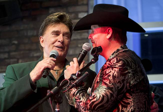 Country singer T.J. Sheppard, left, performs with John Rich during the grand opening of John Rich's Redneck Riviera, a country bar in the Grand Bazaar Shops in front of Bally's, Thursday, Feb. 16, 2017. .