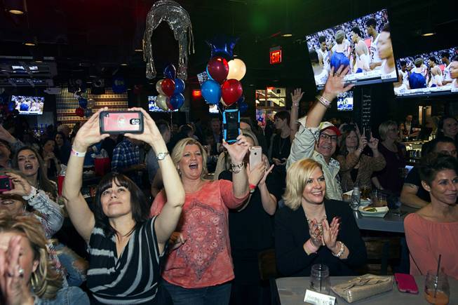 Guests react to a performance by country singer T.J. Sheppard during the grand opening of John Rich's Redneck Riviera, a country bar in the Grand Bazaar Shops in front of Bally's, Thursday, Feb. 16, 2017. .