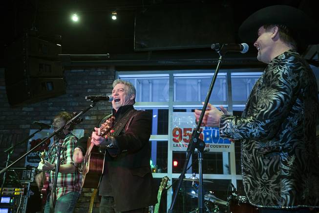 Country singer Larry Gatlin, center, performs during the grand opening of John Rich's Redneck Riviera, a country bar in the Grand Bazaar Shops in front of Bally's, Thursday, Feb. 16, 2017. .