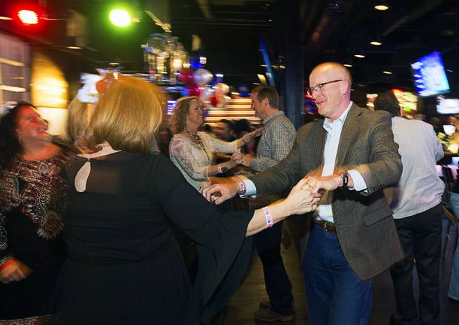 Couples dance to the Tony Marques Band during the grand opening of John Rich's Redneck Riviera, a country bar in the Grand Bazaar Shops in front of Bally's, Thursday, Feb. 16, 2017. .