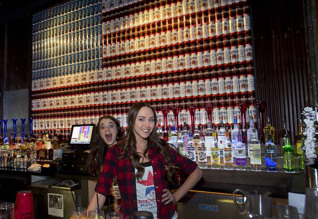 Bartenders pose for a photo during the grand opening of John Rich's Redneck Riviera, a country bar in the Grand Bazaar Shops in front of Bally's, Thursday, Feb. 16, 2017. .