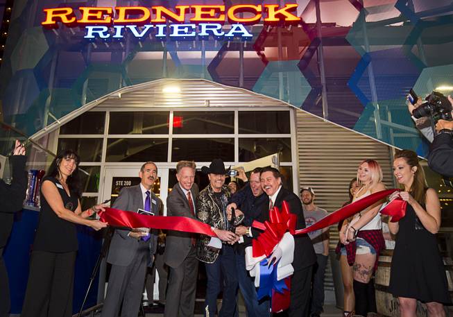 Country singer John Rich, center, of the music duo Big & Rich, and guest cut a ceremonial ribbon during the grand opening of Redneck Riviera, a country bar in the Grand Bazaar Shops in front of Bally's, Thursday, Feb. 16, 2017. From left: Art Goldberg of the Las Vegas Metro Chamber of Commerce, Lynn Holt, vice president of marketing for Bally's, Paris, and Planet Hollywood, John Rich, T.J. McDaniel, vice president and general manager for Redneck Riviera Brands, and Allen Bowman, general manager of Grand Bazaar Shops. .