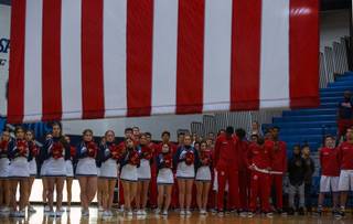 Coronado players and cheerleaders join in the National Anthem during their Sunrise Regional high school basketball championship game at Canyon Springs High School on Saturday, Feb. 18, 2017.