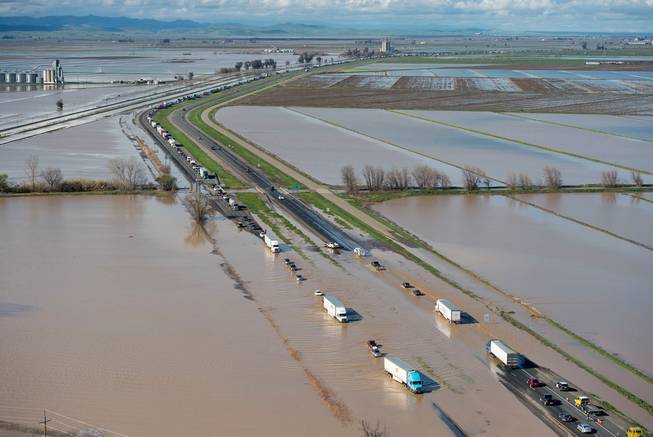 In this view looking north, floodwater crosses over Interstate 5 in Williams, Calif., backing up traffic in both northbound and southbound lanes for hours on Saturday, Feb. 18, 2017. Northern California and the San Francisco Bay Area were facing a weekend return of heavy rain and winds that lashed them earlier in the week before the storm moves out.