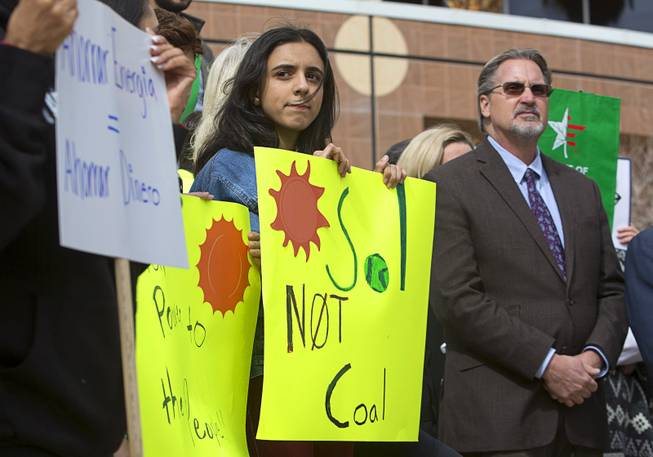 Leez Alkhoury, left, a senior at Chaparal High School, and Ron Nelsen, owner of Pioneer Overhead Door, attend a clean energy rally in front of the Sawyer State Building Monday, Feb. 20, 2017. .