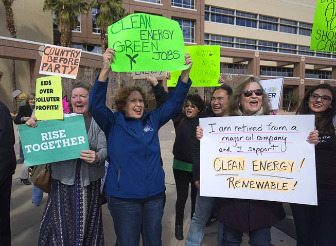 Kathy Lauckner, left, Donna West, center, and Deb Lomando chant during a clean energy rally in front of the Sawyer State Building Monday, Feb. 20, 2017. .