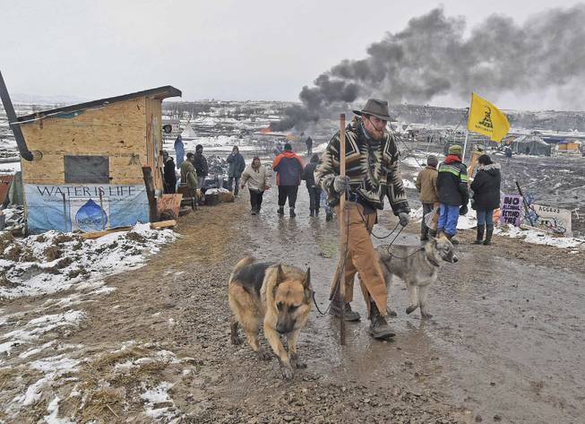 Jasper Spillman, of Lawrence, Kan., leaves the protest camp as opponents of the Dakota Access pipeline leave their main protest camp Wednesday, Feb. 22, 2017, near Cannon Ball, N.D. Most of the pipeline opponents abandoned their protest camp Wednesday ahead of a government deadline to get off the federal land, and authorities moved to arrest some who defied the order in a final show of dissent. (Tom Stromme/The Bismarck Tribune via AP)