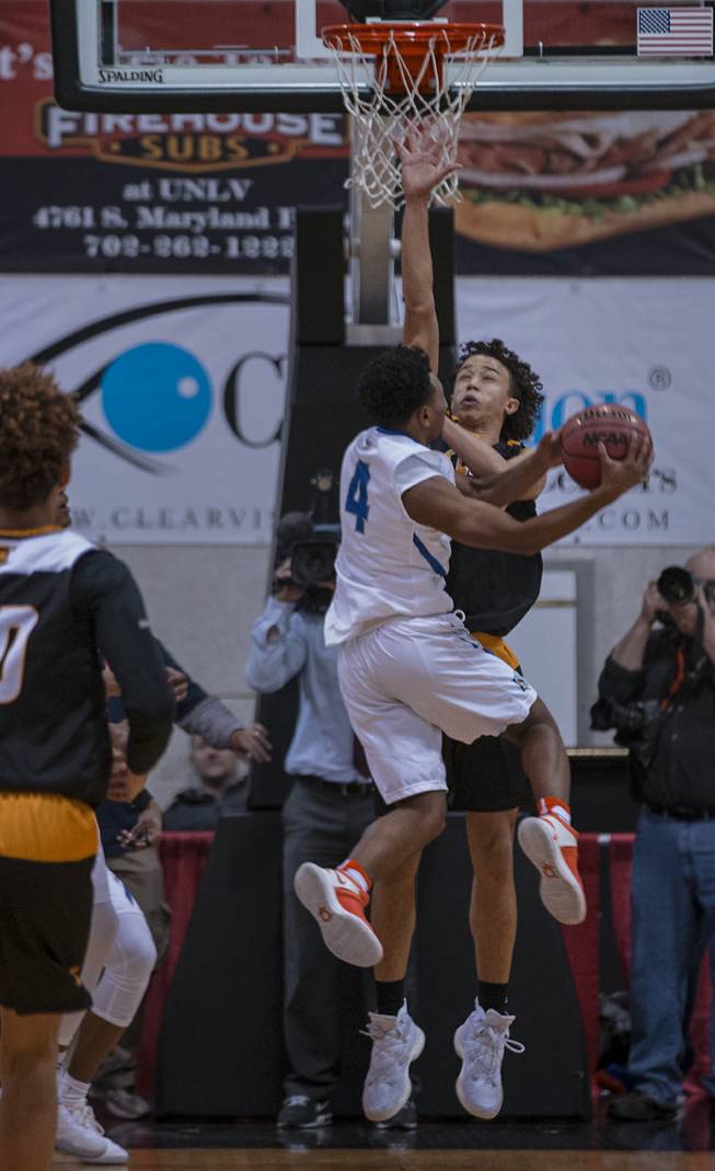 Bishop Gorman guard DJ Howe (4) drives into a Clark defender during their state 4A high school championship game at the Cox Pavilion on Friday, February 24, 2017.