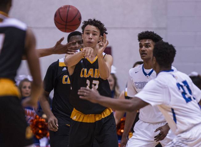 Clark guard Ian Alexander (32) flicks off a pass versus Bishop Gorman players during their state 4A high school championship game at the Cox Pavilion on Friday, February 24, 2017.