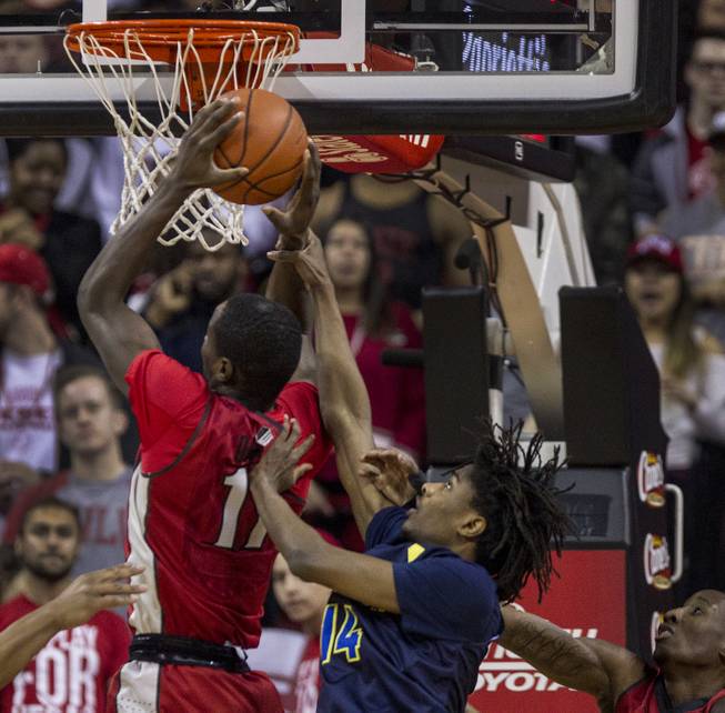 UNLV forward Cheickna Dembele (11) snatches a rebound from over ...