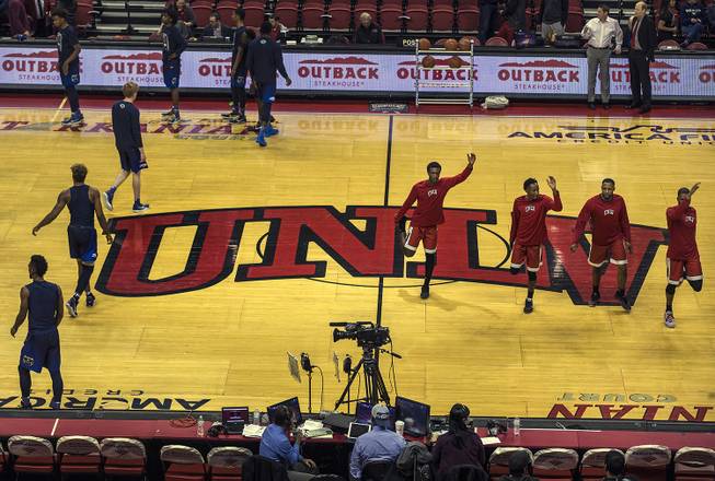 Players warm up from UNLV and UNR prior to their game at the Thomas & Mack Center.