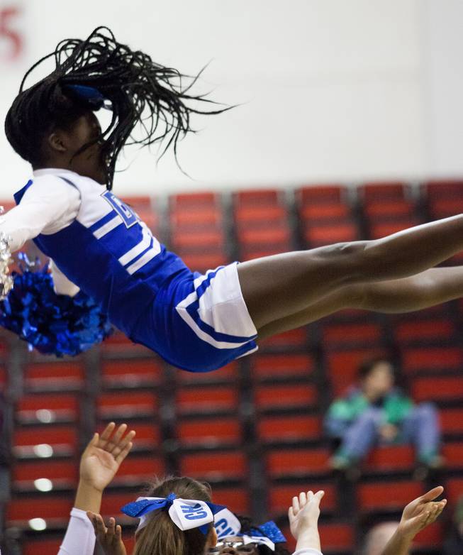 Desert Pines cheerleaders perform a stunt during the high school basketball 3A state title game at Cox Pavilion on Saturday, Feb. 25, 2017. Desert Pines beat Cheyenne 69-44 to claim the title.