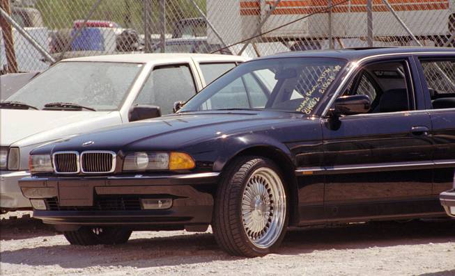 In this Sept. 8, 1996, file photo, a black BMW riddled with bullet holes is seen in a Las Vegas police impound lot. Rapper Tupac Shakur was shot while riding in the car driven by Death Row Records Chairman Suge Knight on Sept. 7, 1996, and died six days later.