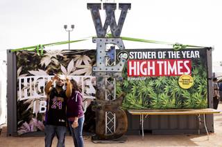 A man and woman take a selfie with a large weed sculpture at the High Times U.S. Cannabis Cup in Moapa Valley, NV, Saturday, March 4, 2017.