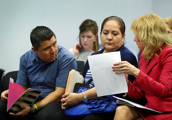 Luis and Olivia Espinoza confer with Marianne Lanuti, right, an attorney specializing in special education, as they wait for a Nevada Senate Committee on Education video conference at the Sawyer State Building Tuesday, March 7, 2017.
