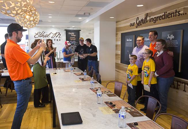 NASCAR driver Kyle Busch poses with the Panariso family during an appearance at the Ethel M Chocolates factory in Henderson Thursday, March 9, 2017.