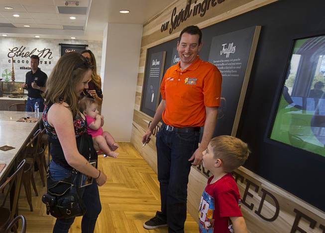 NASCAR driver Kyle Busch chats with Riley Davis, 6, and his mother Cheree Davis during an appearance at the Ethel M Chocolates factory in Henderson Thursday, March 9, 2017.