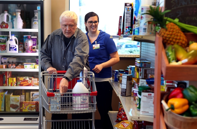 Arthur Schroeck practices grocery shopping with occupational therapist Danielle Oberg ...