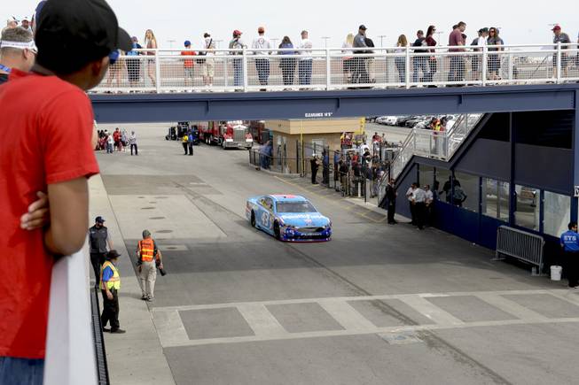 Fans watch as #43 Aric Almirola passes under them on his way to the track during NASCAR Stratosphere Pole Day at Las Vegas Motor Speedway. Friday, March 10, 2017.