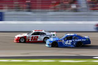 Joey Logano, left, races with Kyle Larson during the Boyd Gaming 300, a NASCAR Xfinity Series auto race, at the Las Vegas Motor Speedway Saturday, March 11, 2017, in Las Vegas. Logano won the race. Larson came in second.