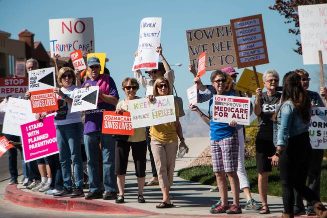 Protesters gather outside a closed-door event held by Senator Dean Heller, R-Nev., at Sun City Anthem on March 11, 2017, in Henderson.