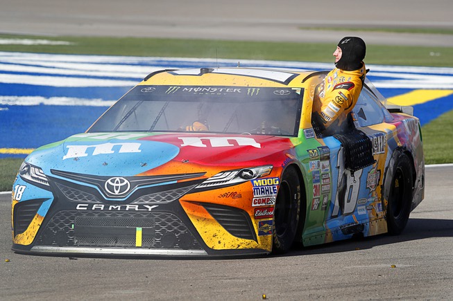 Kyle Busch climbs out of his car in the pit ...