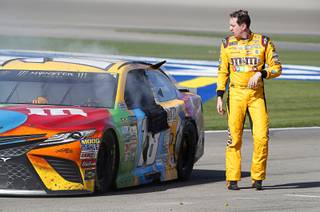 Kyle Busch walks away from his car in the pit area at the end of the Kobalt 400, a NASCAR Monster Energy Cup Series race, at the Las Vegas Motor Speedway Sunday, March 12, 2017. Busch got into an accident with Joey Logano as they raced for third place, sending Busch spinning down pit road. 