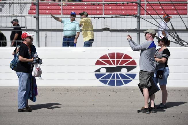Fans take a quick photo on the track before the Monster Energy NASCAR Cup Series Kobalt 400 Sunday, March 12, 2017, at the Las Vegas Motor Speedway.