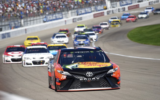 Martin Truex Jr. leads the field into turn one during ...
