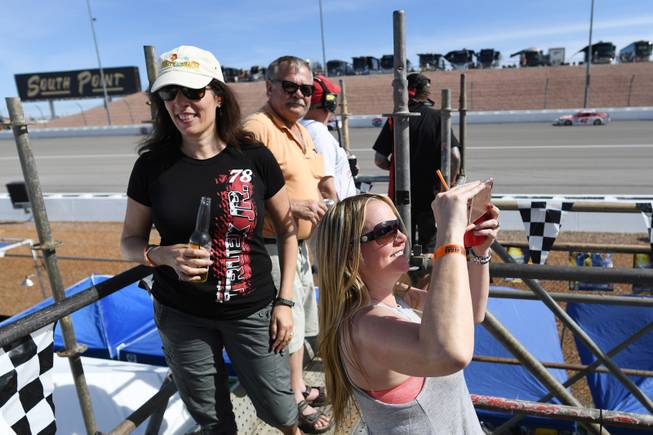 Race fans watch the action from the top of scaffolding during the Monster Energy NASCAR Cup Series Kobalt 400 Sunday, March 12, 2017, at the Las Vegas Motor Speedway.