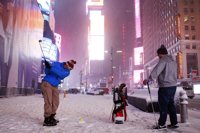 Two men play golf with a tennis ball as a ...