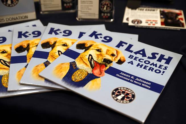 Copies of "K-9 Flash Becomes A Hero!" are displayed during the annual Police K-9 Conference and Vendor Show at the Tuscany Thursday, March 16, 2017. The children's book chronicles the true story of Flash, a rescue dog who becomes a narcotics-sniffing dog with the City of Yakima Police Department.