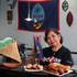 Carmen Taitague Tenorio displays her restaurant’s Fiesta Plate and Chamorro beignets.