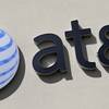 This Wednesday, Feb. 8, 2017, file photo shows the AT&T sign at a store in Hialeah, Fla.