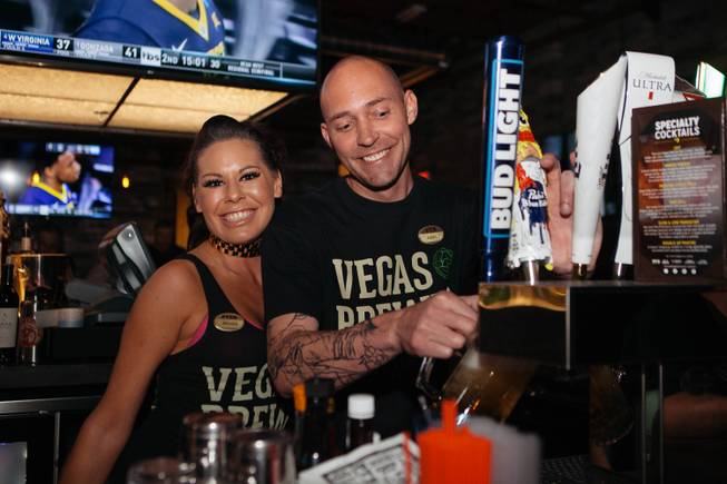 Monica and Adam pour some beers for customers during the grand opening party at PTs Pub located at 7355 S Buffalo Dr, in Las Vegas, Nev. on March 23, 2017.