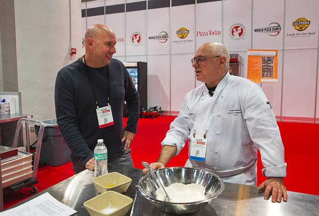 Metro Pizza's Chris Decker, left, talks with baker and author Peter Reinhart during the International Pizza Expo at the Las Vegas Convention Center Tuesday, March 28, 2017.
